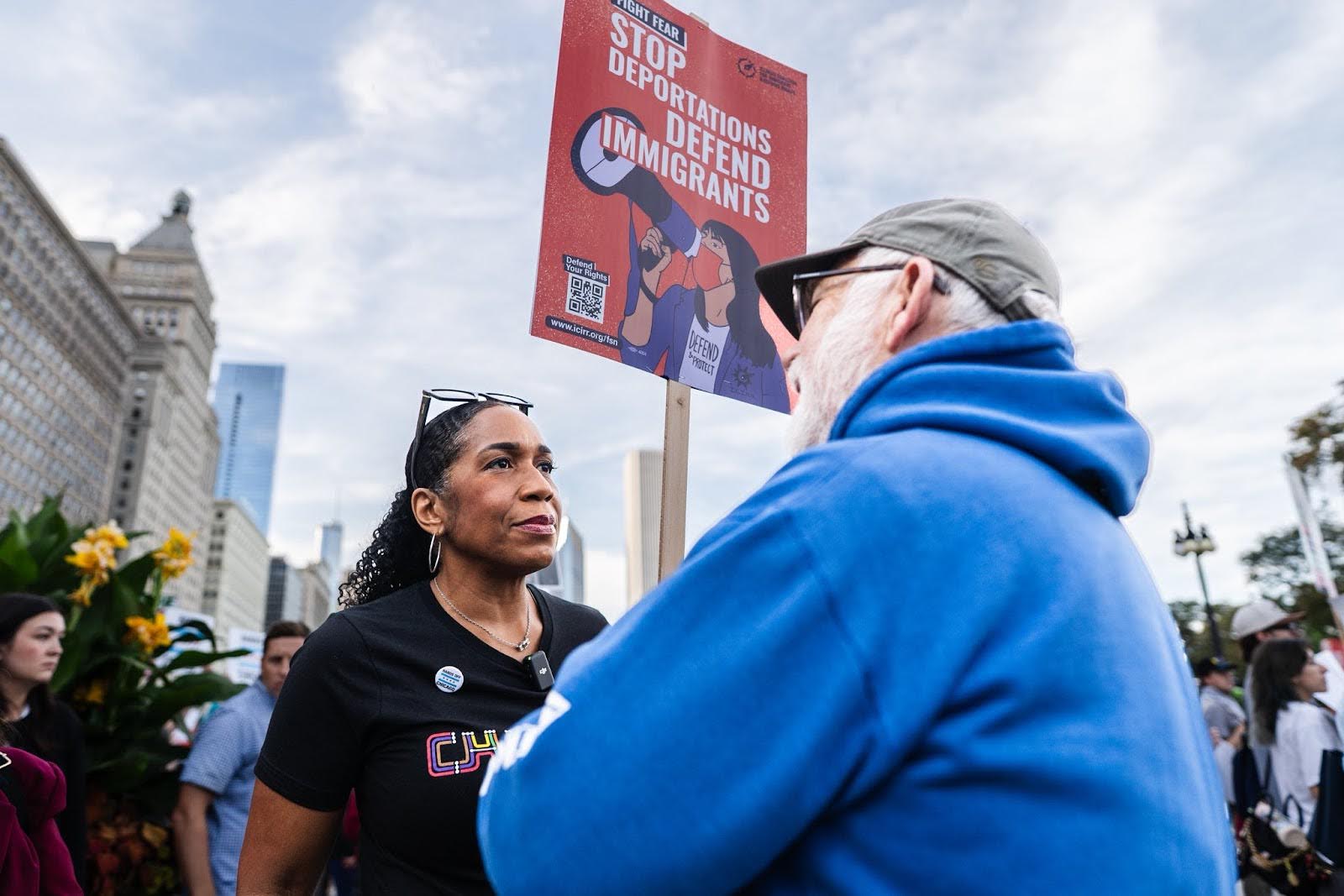 Juliana speaking with a protest attendee